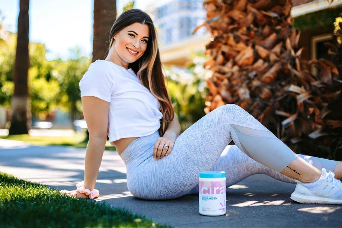 Collagen for hair growth: woman sitting on the ground with a Cira jar beside her