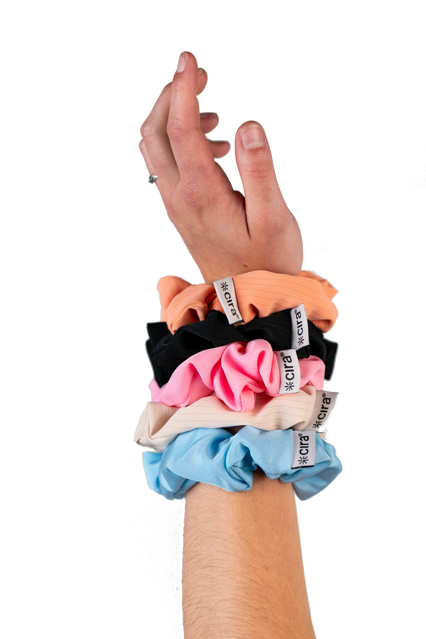 A woman's wrist with the complete collection of Cira Nutrition Scrunchies in Orange, Black, Pink, Beige, and Blue